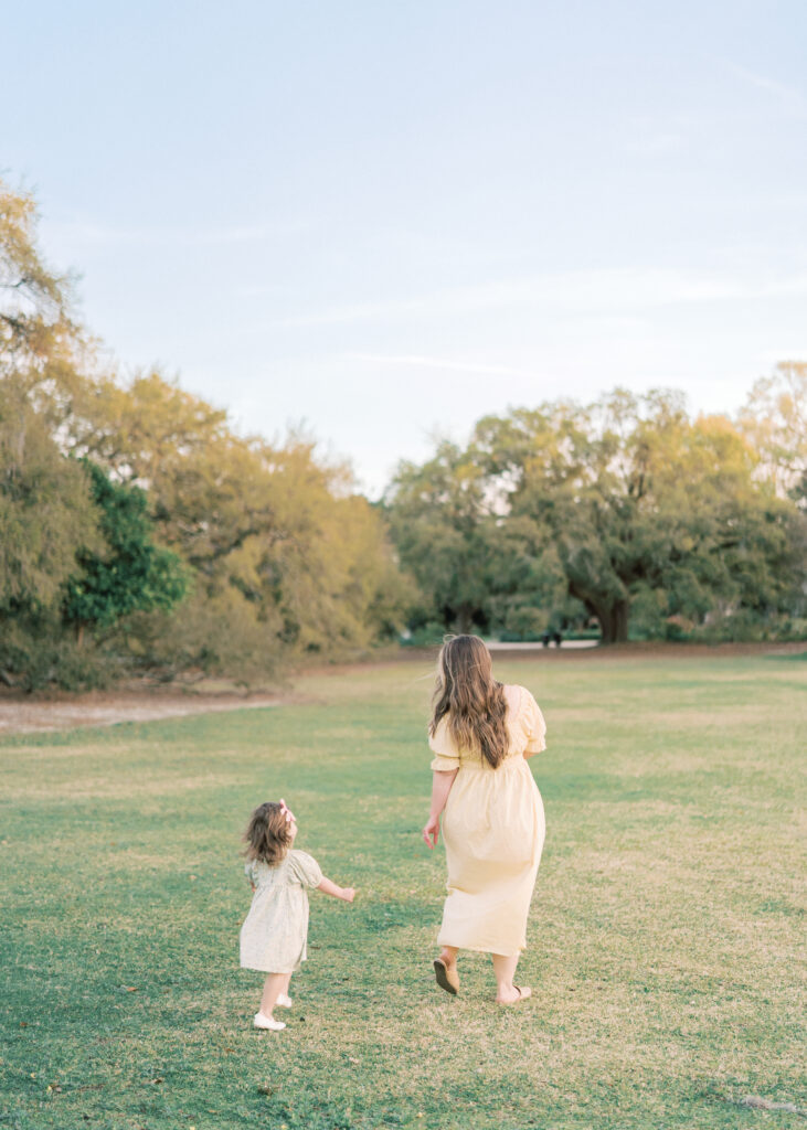 mom and daughter running through Hampton Park